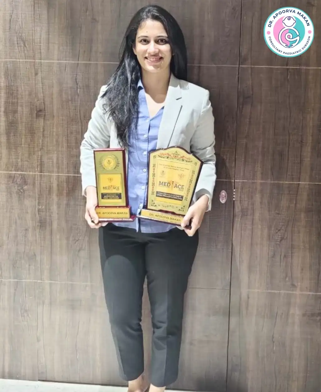 Dr. Apoorva Makan holding awards of Pediatric Surgery.