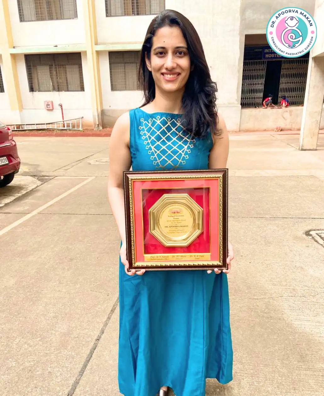Dr. Apoorva Makan holding award trophy.
