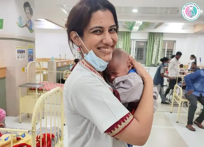 Dr. Apoorva Makan holding small baby in her hands.