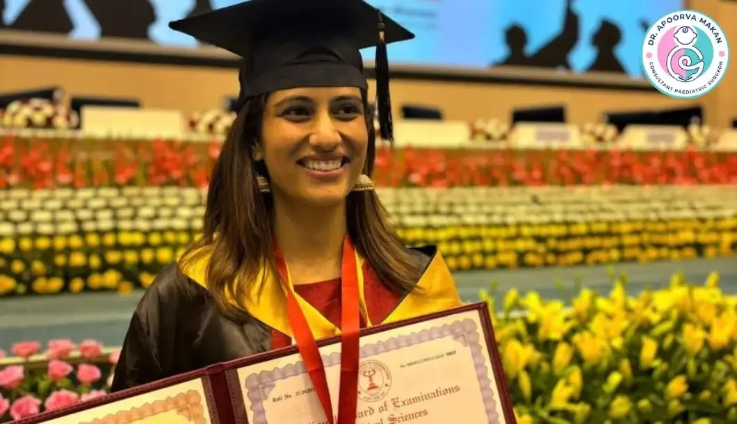 Dr. Apoorva Makan wearing gold medals and holding her DNB (Pediatric Surgery) certificate.