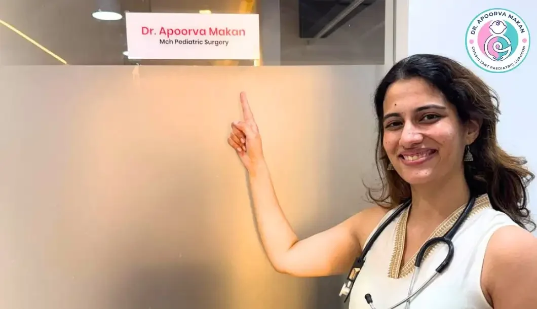 Dr. Apoorva Makan pointing to her name plate in her clinic.