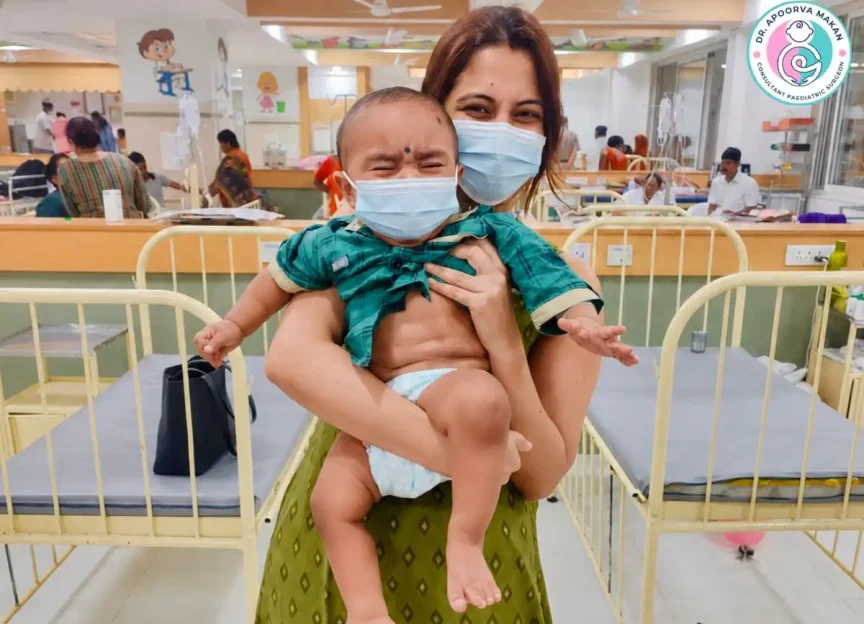 Dr. Apoorva Makan holding baby after surgery at a hospital.